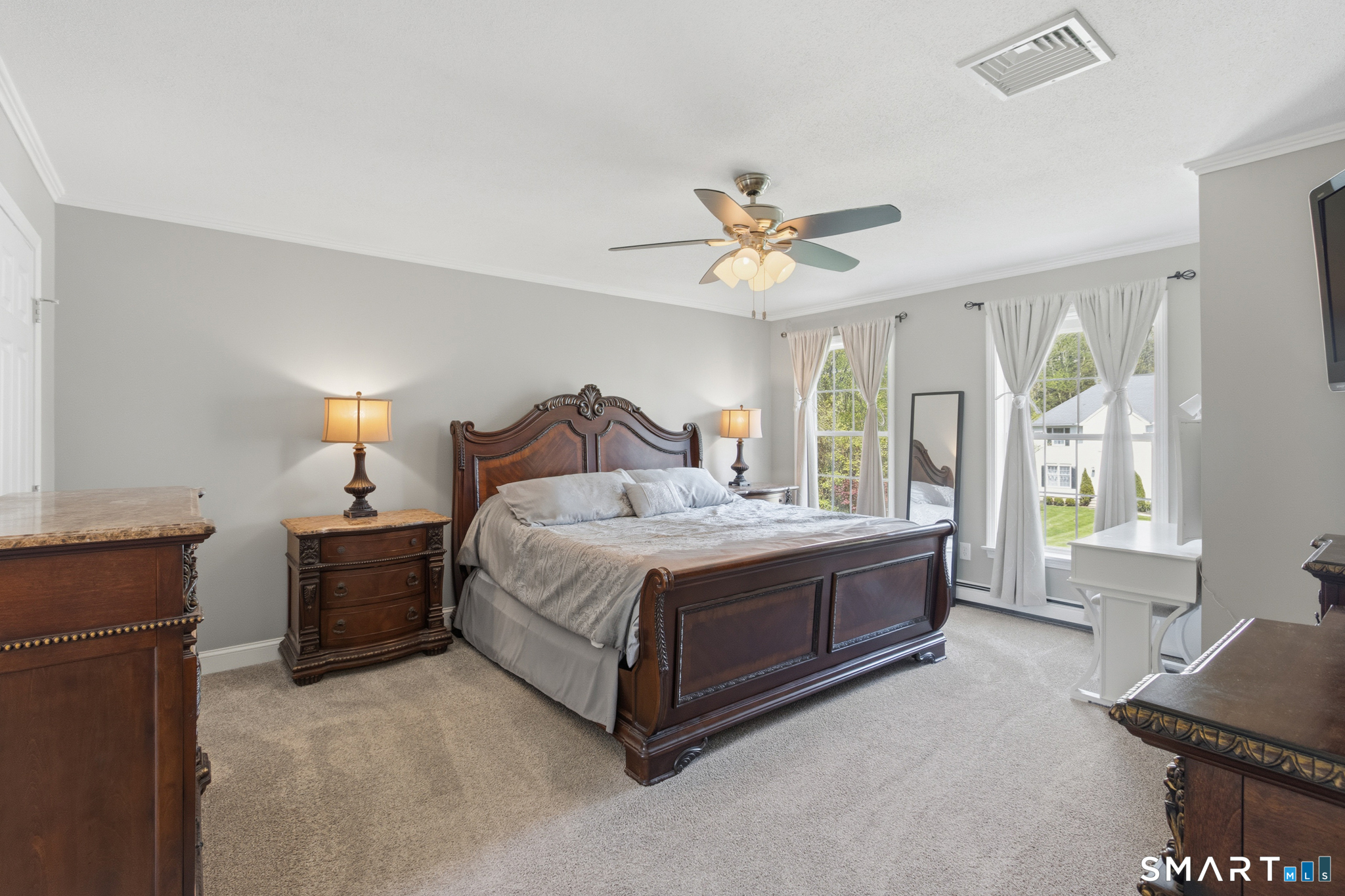 5 Ice Pond Road Granby, CT 06035 - Photo 26 of 40 a spacious bedroom with a bed and a chandelier
