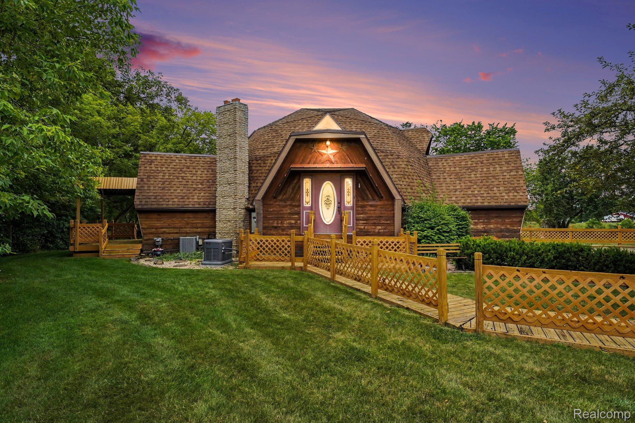 4425 North Henderson Road Davison, MI 48423 - Photo 1 of 43 Distinctive A-frame style home featuring a prominent stone chimney
