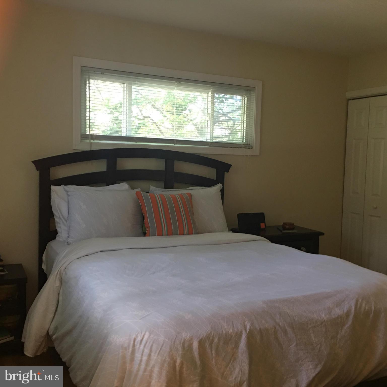 13306 Lydia Street Silver Spring, MD 20906 - Photo 12 of 30 a bed sitting in a bedroom next to a window