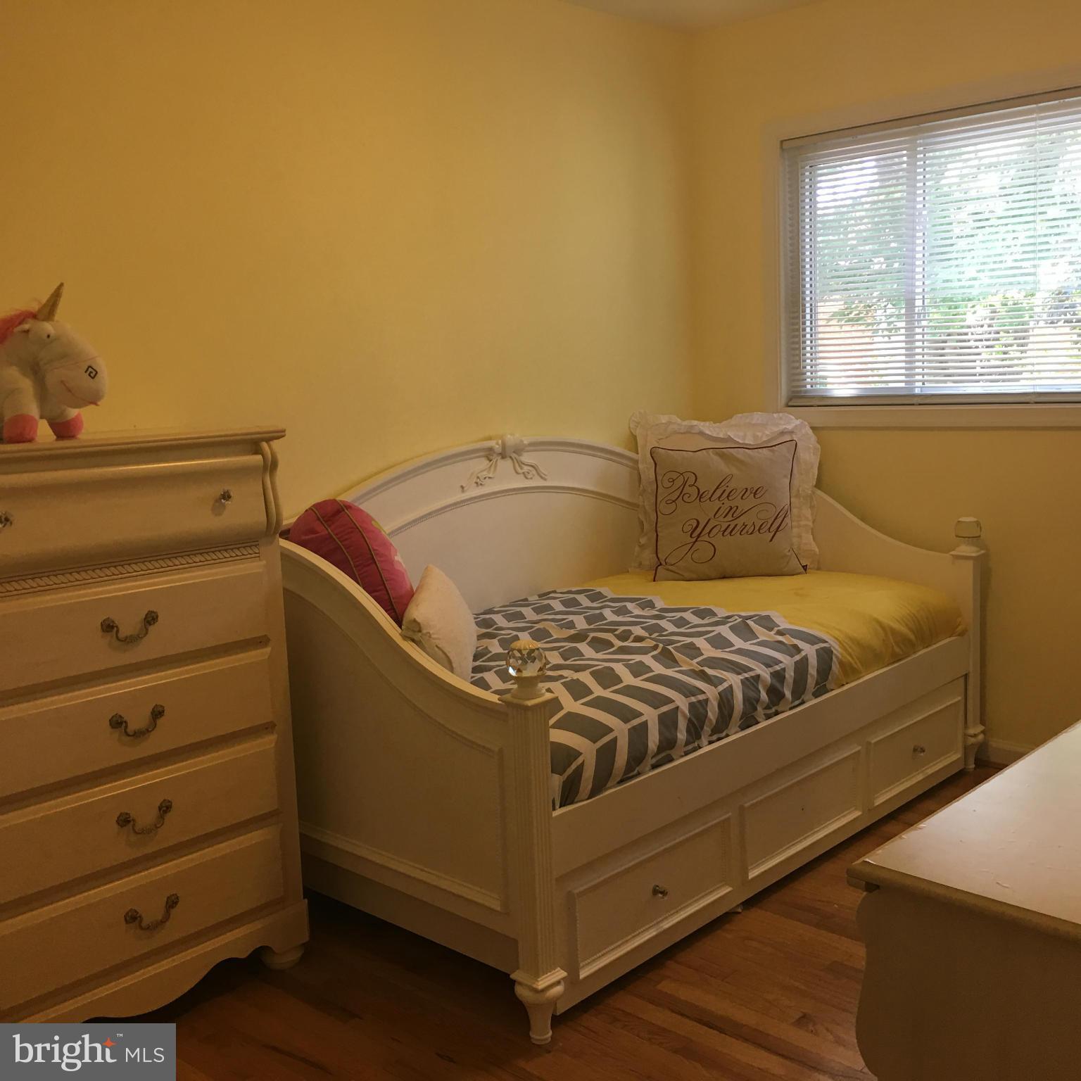 13306 Lydia Street Silver Spring, MD 20906 - Photo 15 of 30 a bed sitting in a bedroom next to a window