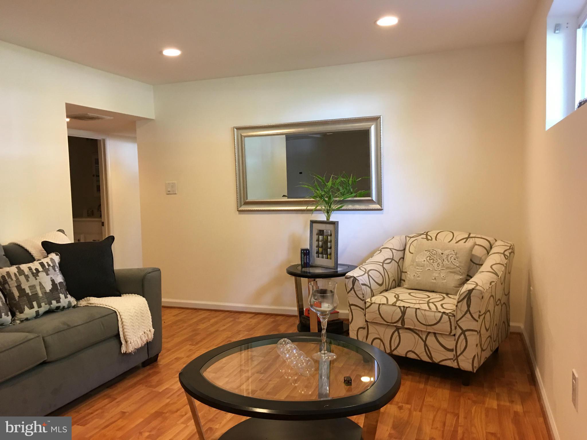 13306 Lydia Street Silver Spring, MD 20906 - Photo 19 of 30 a living room with furniture and a wooden floor