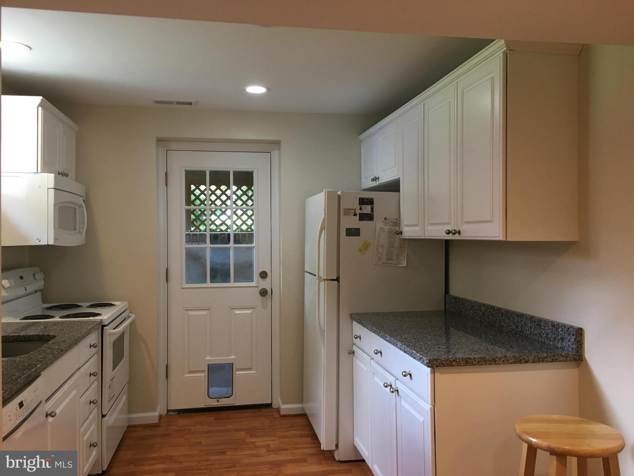 13306 Lydia Street Silver Spring, MD 20906 - Photo 27 of 30 a kitchen with stainless steel appliances granite countertop a refrigerator sink and stove