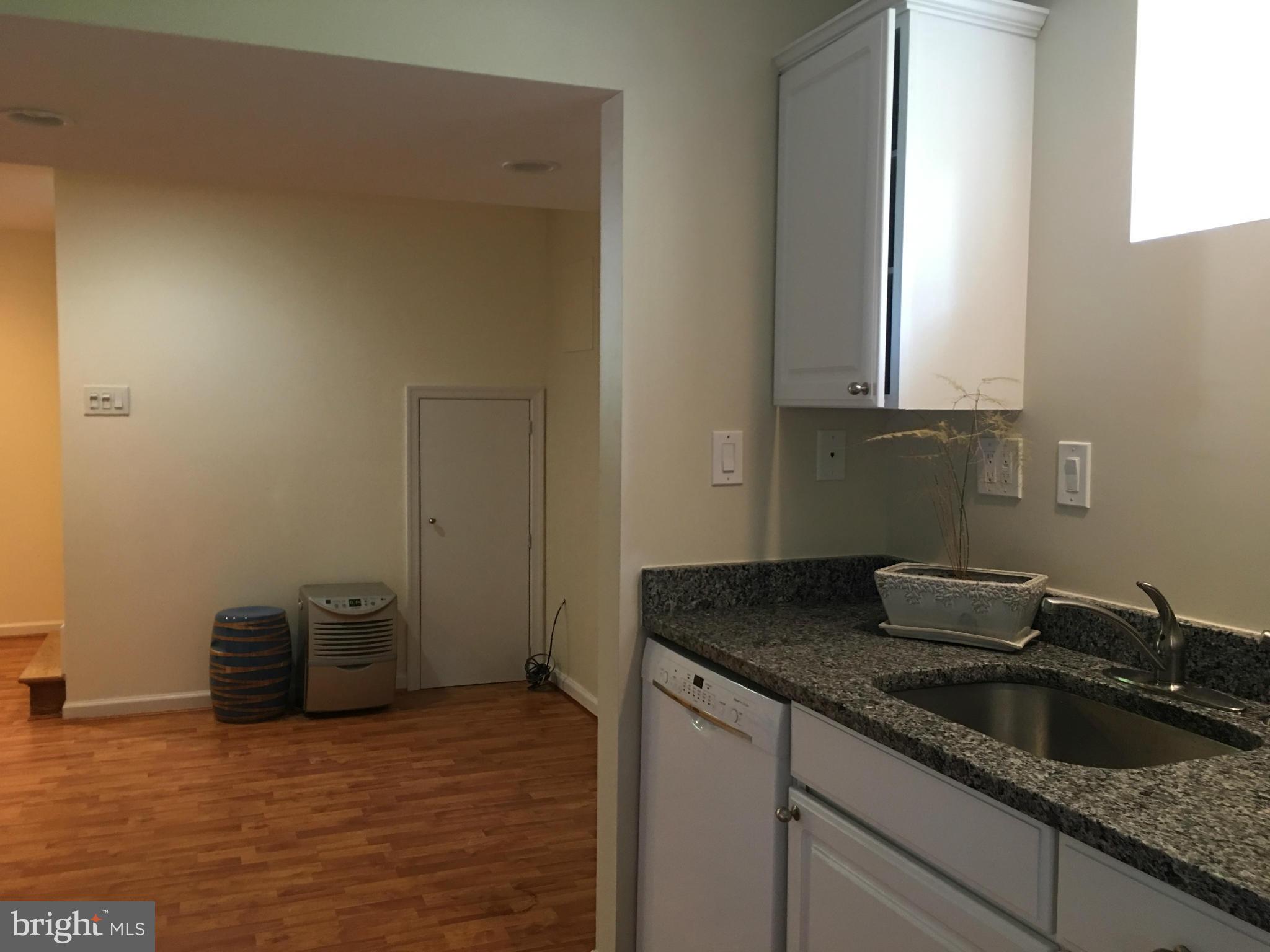 13306 Lydia Street Silver Spring, MD 20906 - Photo 28 of 30 a kitchen with granite countertop a sink and cabinets