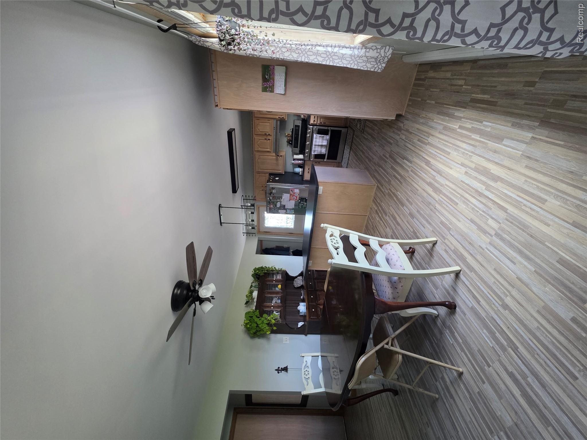 5847 F Road Bark River, MI 49807 - Photo 13 of 25 Dining area with ceiling fan and light wood finished floors
