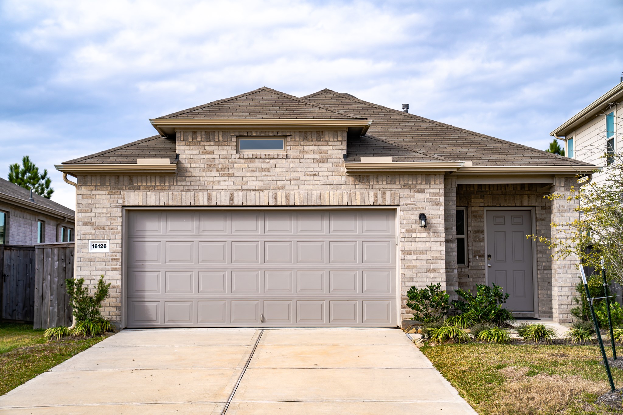 16126 Elbridge Court Conroe, TX 77302 - Photo 1 of 15 a front view of a house with a garden