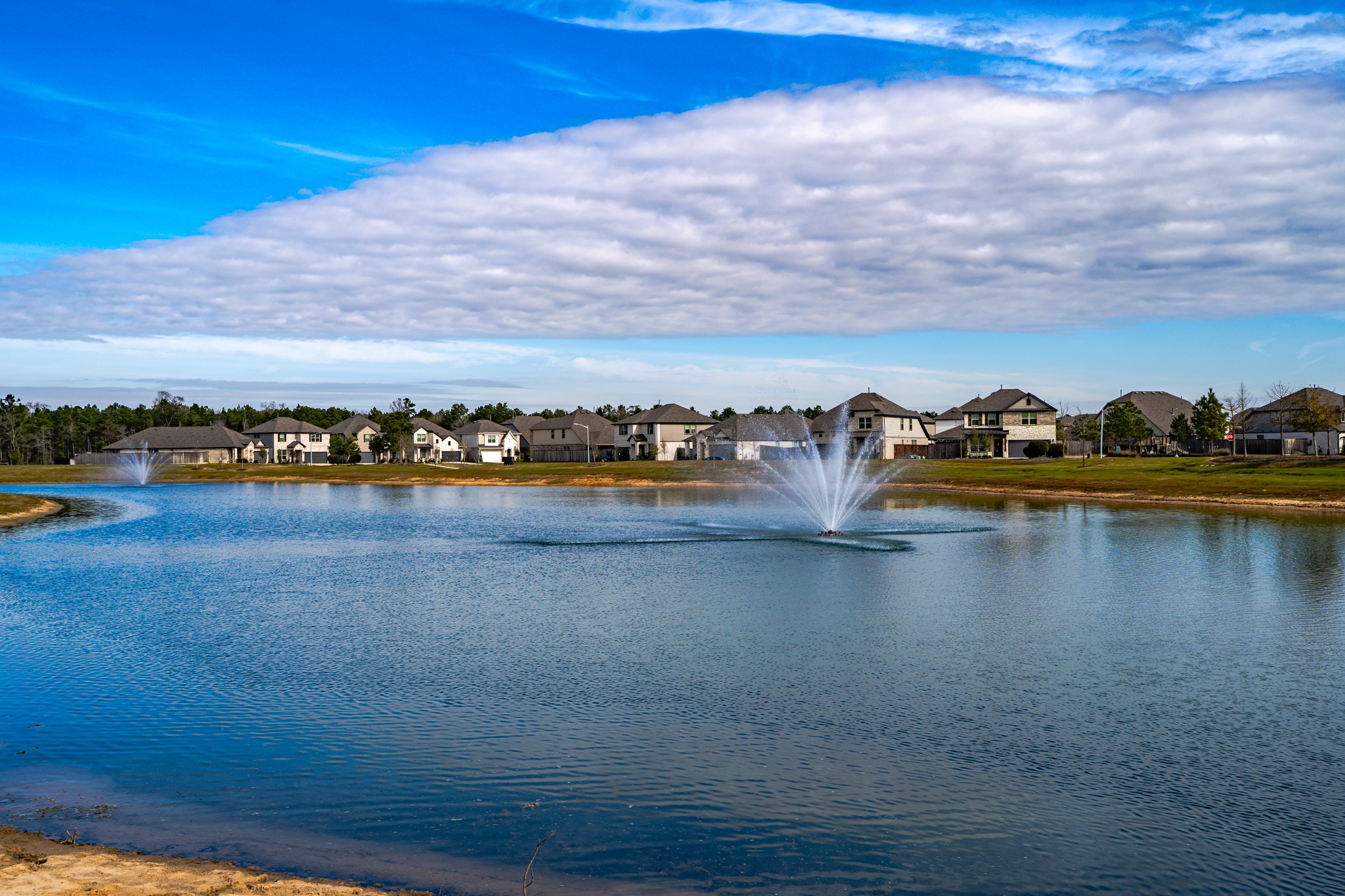 16126 Elbridge Court Conroe, TX 77302 - Photo 15 of 15 a view of a lake with houses in the back