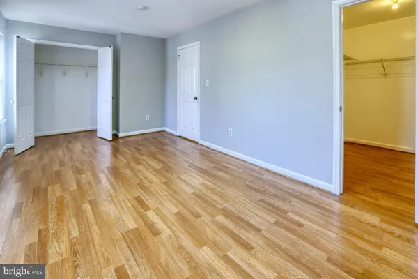 a view of empty room with wooden floor