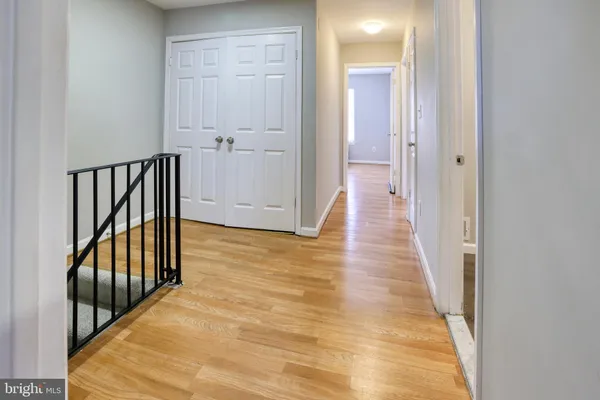 a view of a hallway with wooden floor