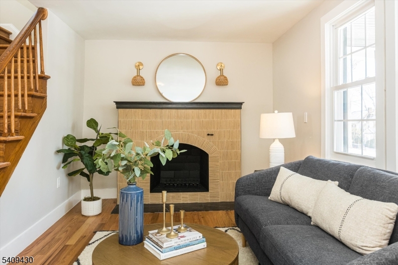 27 Oakridge Road West Orange, NJ 07052 - Photo 11 of 29 a living room with furniture potted plant and a fireplace