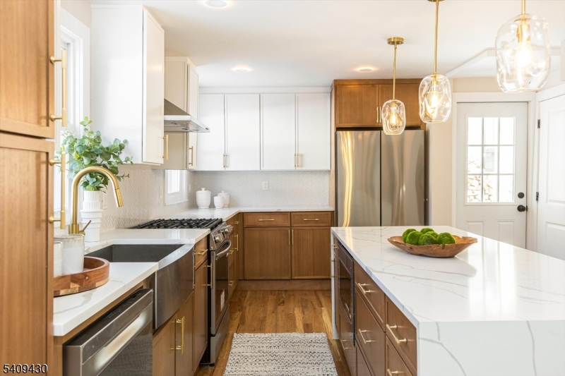 27 Oakridge Road West Orange, NJ 07052 - Photo 18 of 29 a kitchen with granite countertop a sink a counter appliances and cabinets