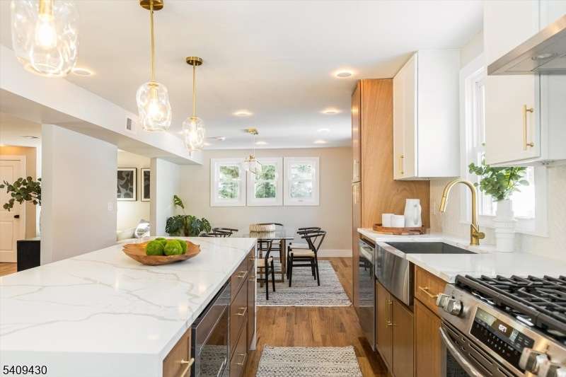 27 Oakridge Road West Orange, NJ 07052 - Photo 19 of 29 a kitchen with sink dining table and chairs