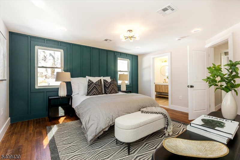 27 Oakridge Road West Orange, NJ 07052 - Photo 21 of 29 a spacious bedroom with a bed and a couch