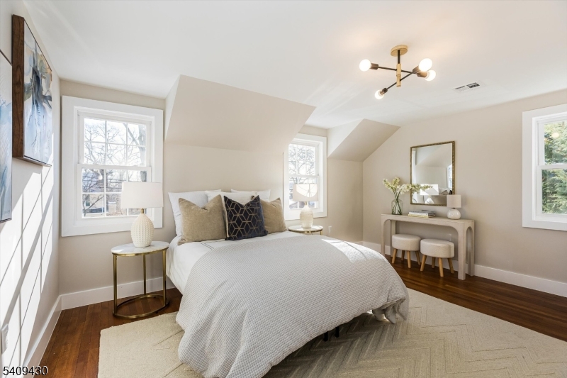 27 Oakridge Road West Orange, NJ 07052 - Photo 23 of 29 a bedroom with a bed and a table in it with window