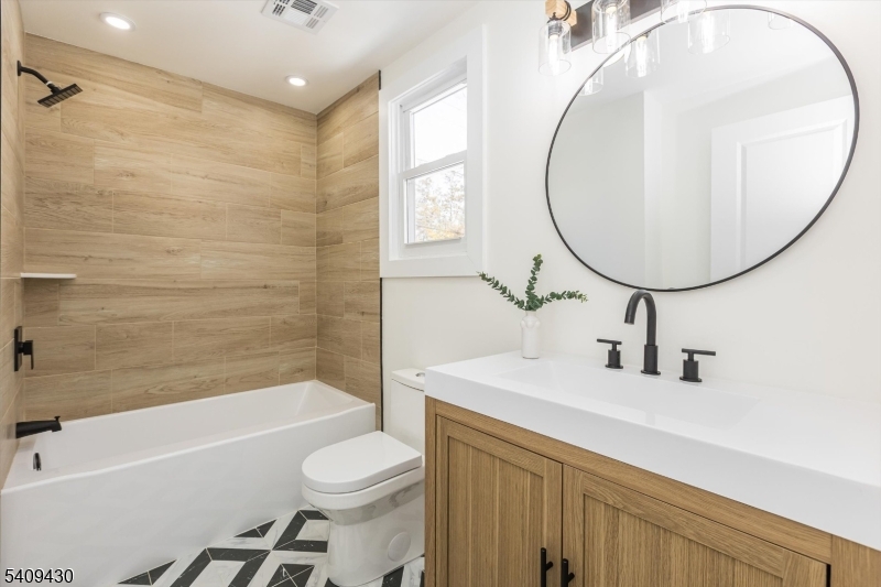 27 Oakridge Road West Orange, NJ 07052 - Photo 25 of 29 a bathroom with a sink a toilet and a mirror
