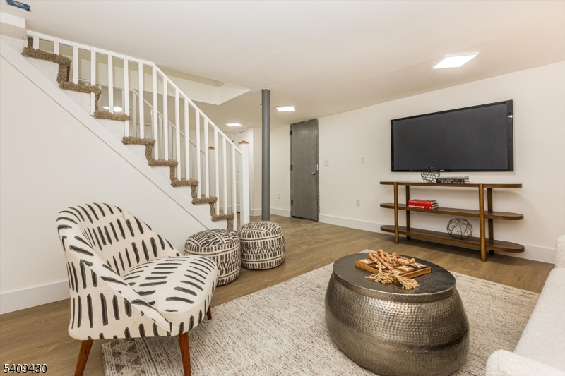 27 Oakridge Road West Orange, NJ 07052 - Photo 27 of 29 a living room with furniture and a flat screen tv