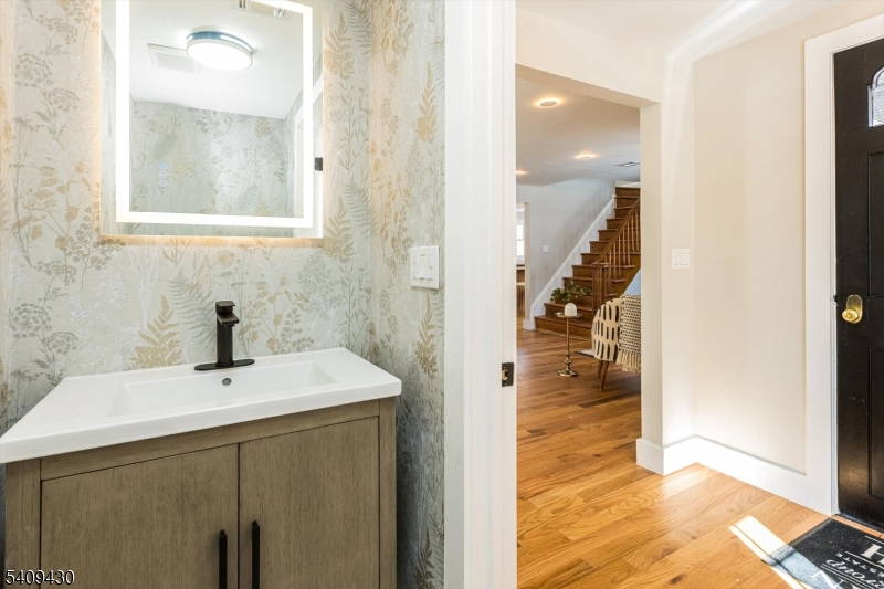27 Oakridge Road West Orange, NJ 07052 - Photo 6 of 29 a bathroom with a sink mirror and shower