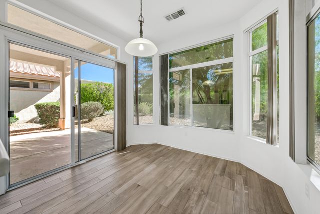 a view of livingroom with furniture wooden floor and a floor to ceiling window