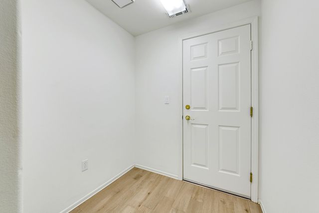 an empty room with wooden floor
