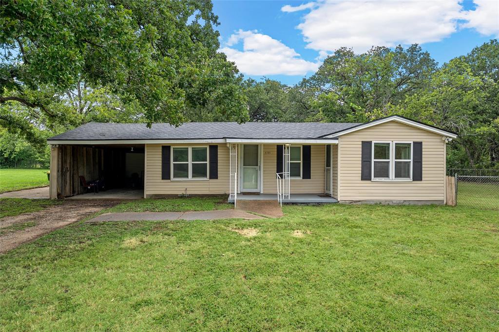 4704 Williams Road Bellmead, TX 76705 - Photo 1 of 32 Ranch-style exterior with beige siding, a dark shingle roof, and a covered carport