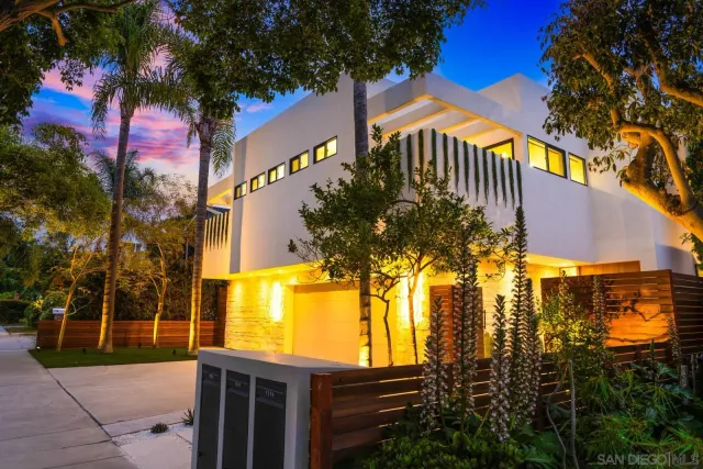 a view of residential house with tree and wooden fence