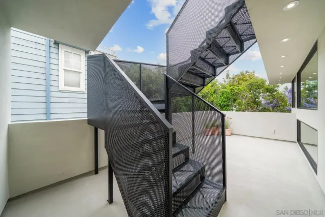 a view of a white house with a yard