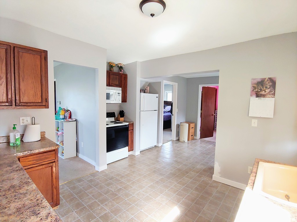 2186-2188 Palmer Road Three Rivers, MA 01080 - Photo 3 of 17 a kitchen with stainless steel appliances granite countertop a refrigerator and a stove top oven