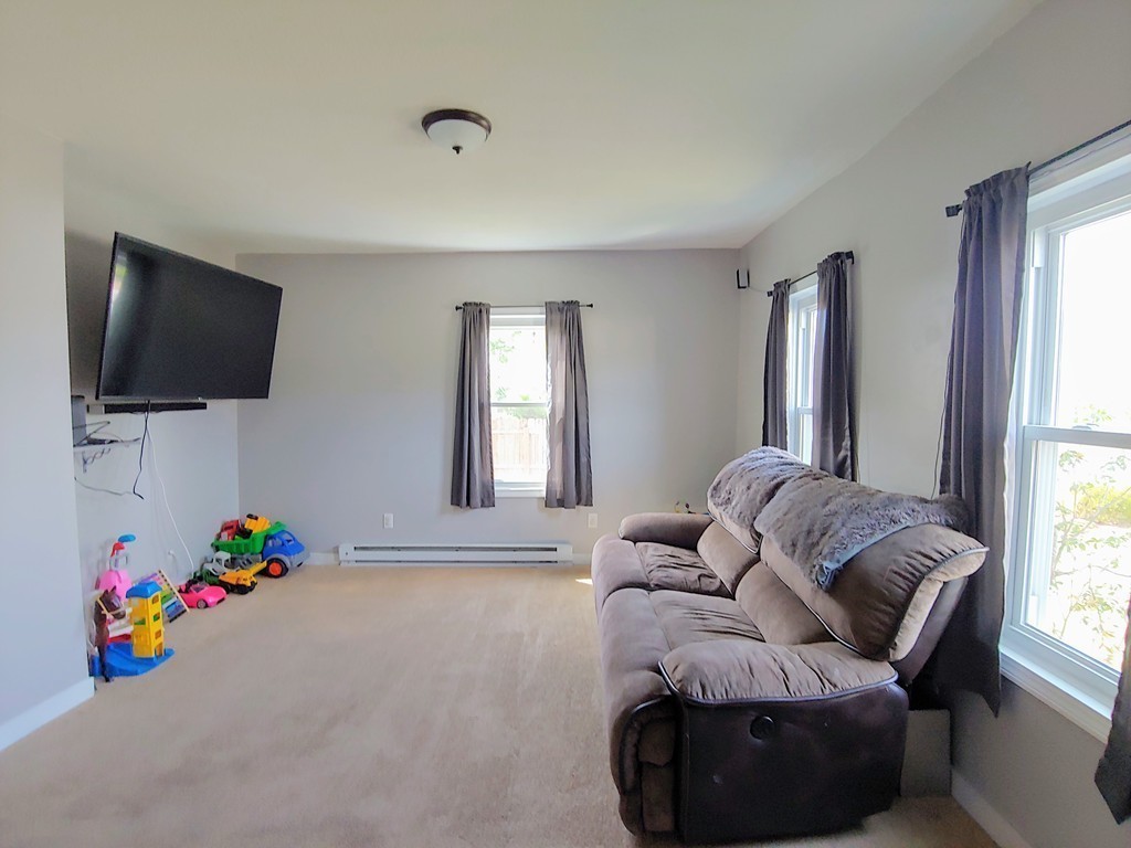 2186-2188 Palmer Road Three Rivers, MA 01080 - Photo 5 of 17 a living room with furniture and a flat screen tv