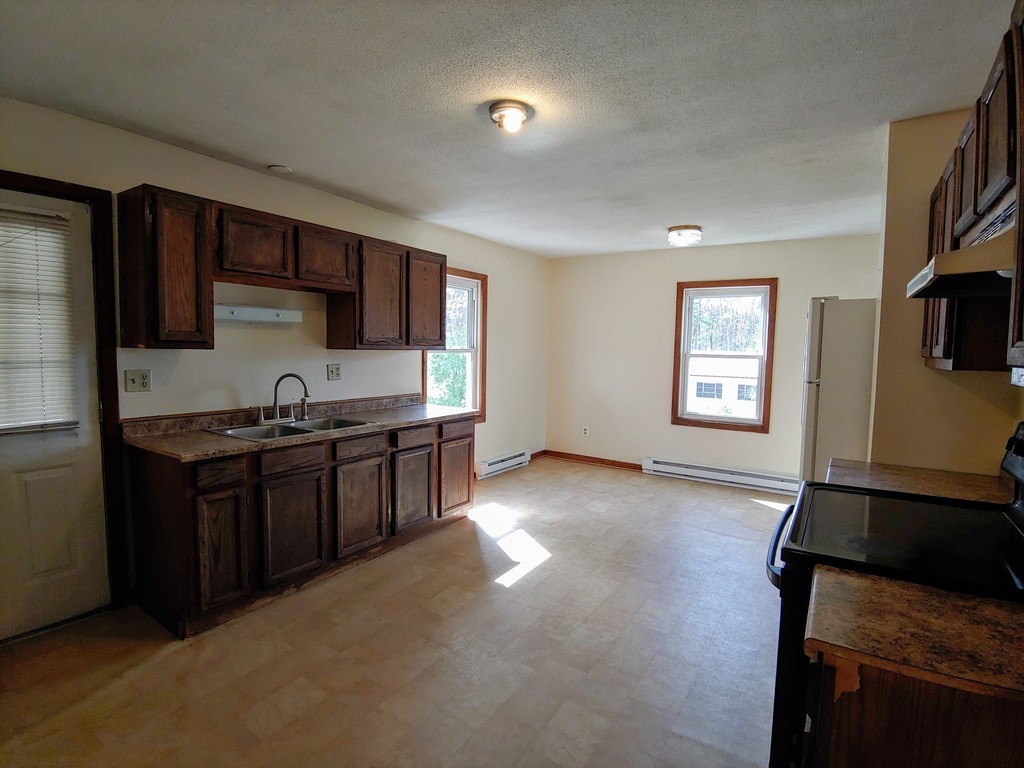 2186-2188 Palmer Road Three Rivers, MA 01080 - Photo 10 of 17 a kitchen with stainless steel appliances granite countertop a stove a sink and a refrigerator