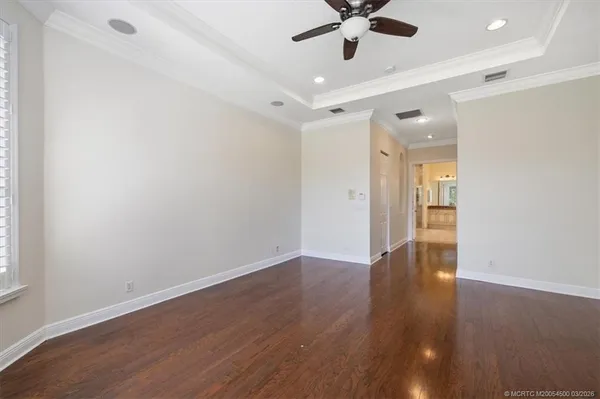a living room with furniture ceiling fan and a window