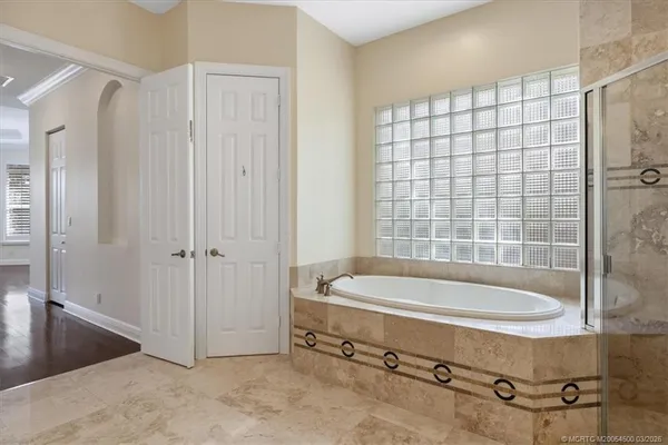 a bedroom with a bed couch and window