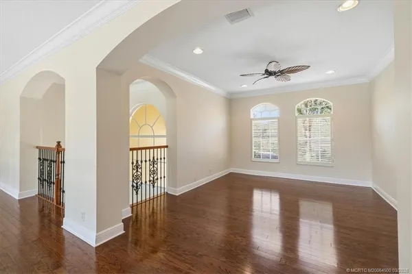 a spacious bedroom with a bed a couch and a window