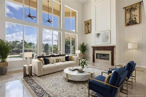 a living room with furniture fireplace and a large window