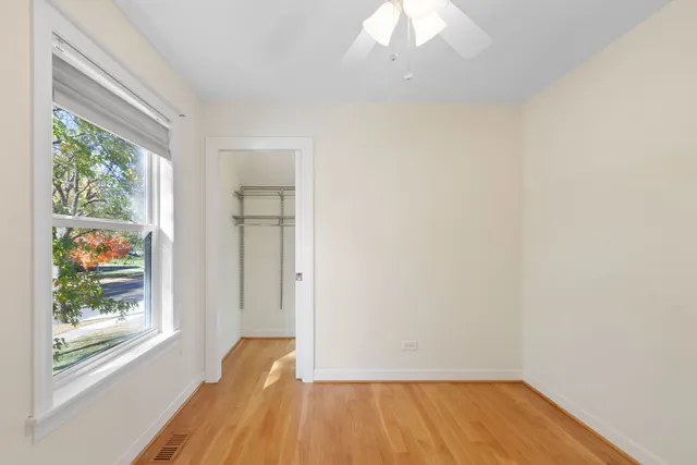 a view of room with window and wooden floor