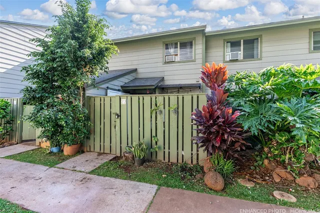 a front view of a house with a garden