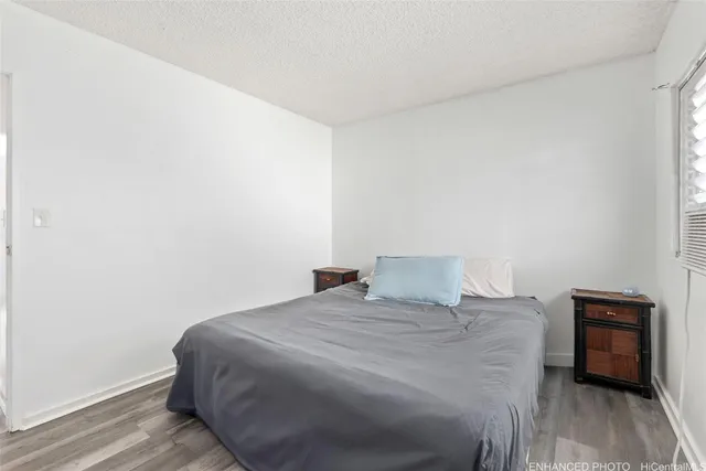 a bedroom with a bed and a tv