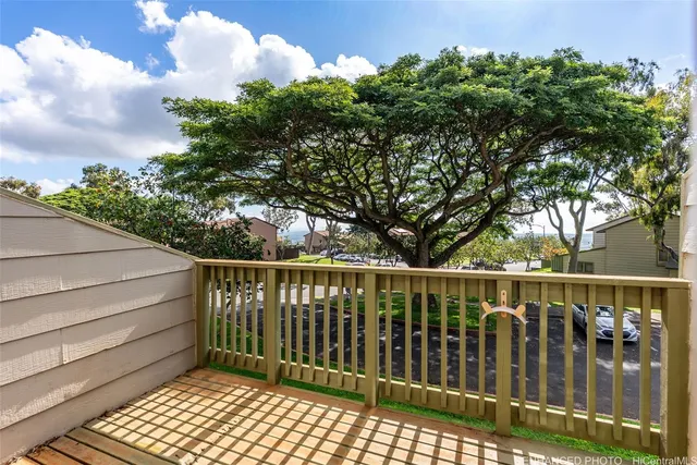a balcony with wooden floor and fence