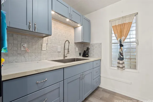 a kitchen with a sink and cabinets