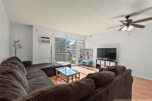 a living room with furniture a flat screen tv and a large window