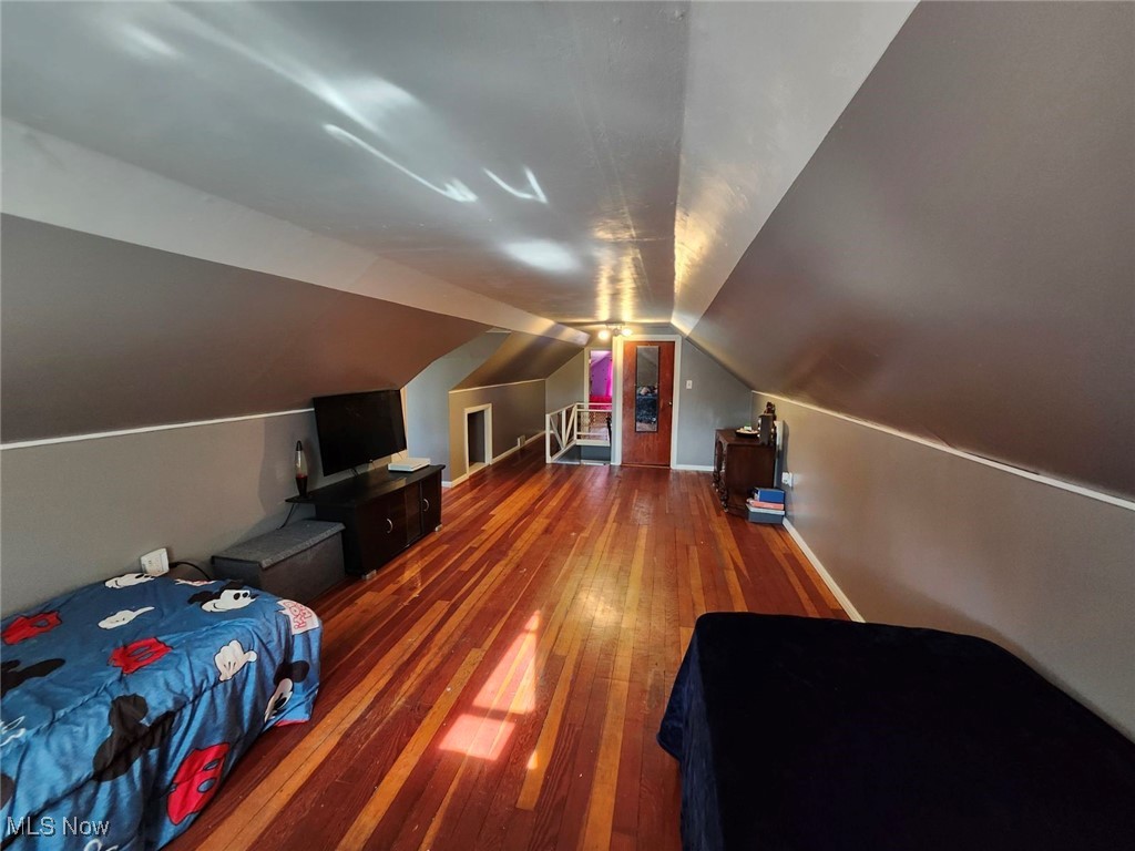 3205 Center Road Ashtabula, OH 44004 - Photo 22 of 29 Bedroom featuring dark wood-type flooring and vaulted ceiling