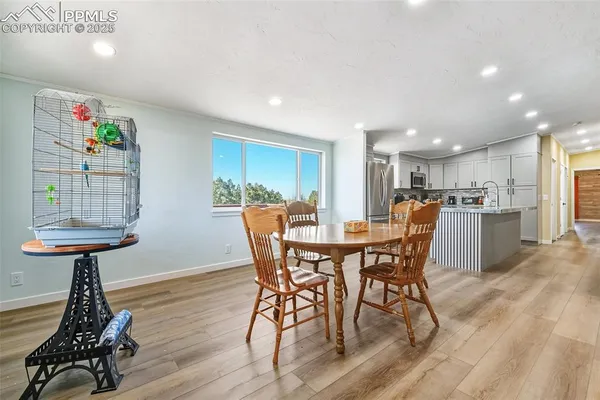 a view of a dining room with furniture and wooden floor
