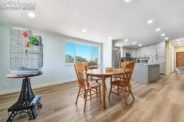 a view of a dining room with furniture and wooden floor
