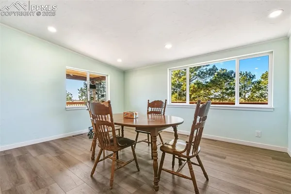 a view of a dining room with furniture window and wooden floor