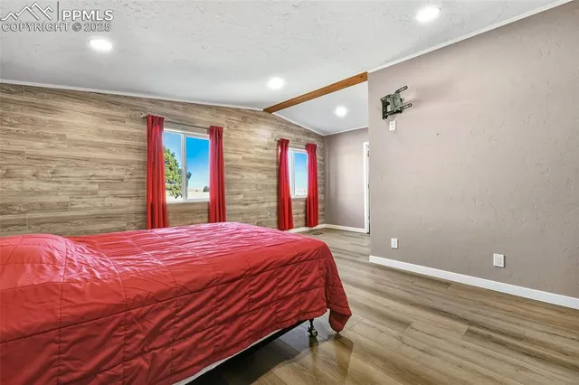 a bedroom with a large bed and a large window