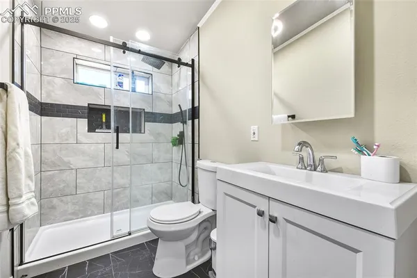 a bathroom with a sink toilet and shower
