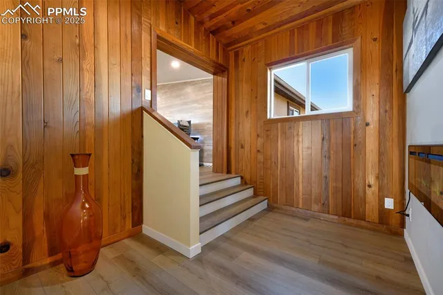 a view of a hallway with wooden floor and entryway