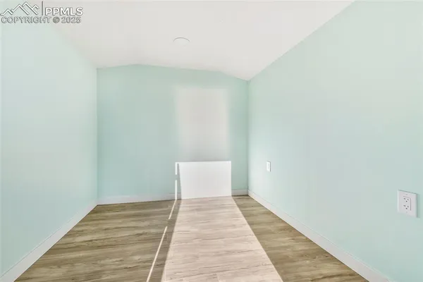a view of a room with wooden floor