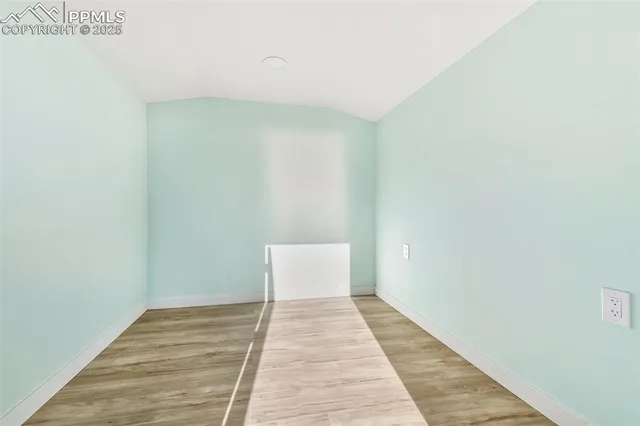 a view of a room with wooden floor