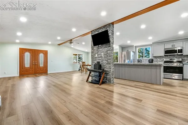 a view of kitchen with furniture and wooden floor