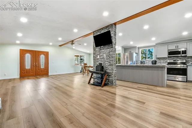 a view of kitchen with furniture and wooden floor