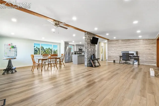 a view of a room with furniture and wooden floor